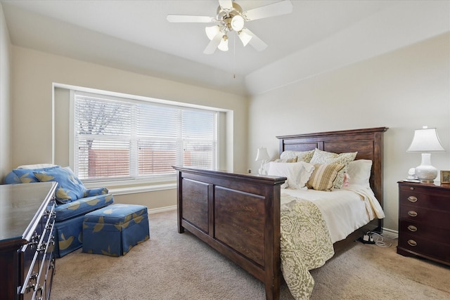 bedroom with vaulted ceiling, light carpet, ceiling fan, and baseboards