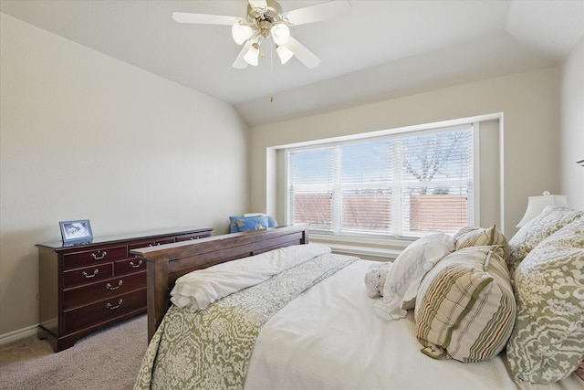 bedroom featuring lofted ceiling, ceiling fan, multiple windows, and light colored carpet