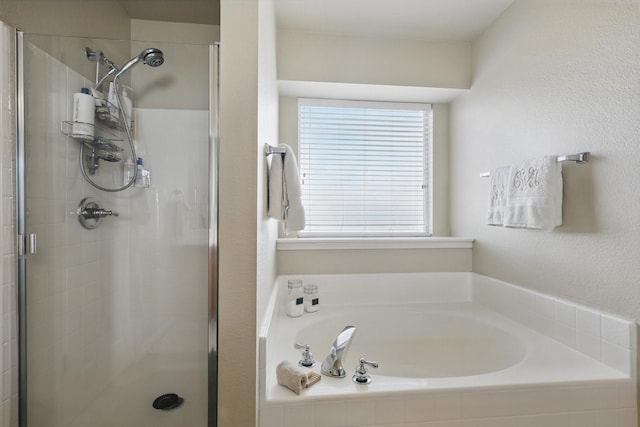 full bathroom featuring a stall shower and a bath