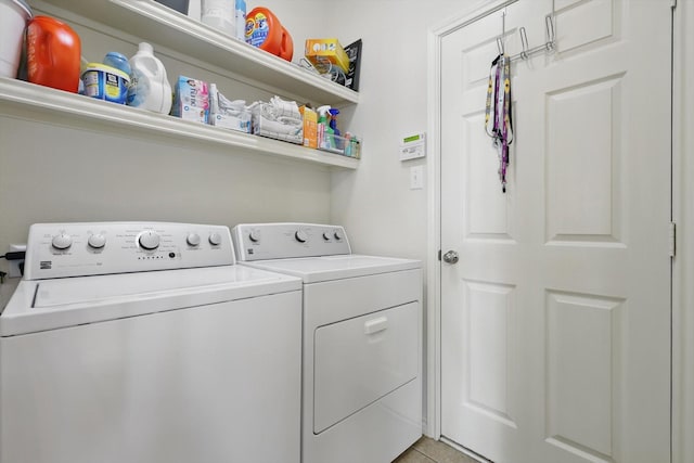 washroom with laundry area, light tile patterned flooring, and washing machine and dryer