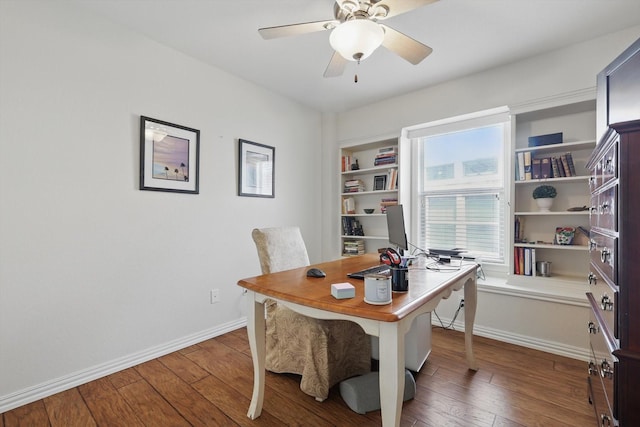 home office with ceiling fan, hardwood / wood-style floors, and baseboards