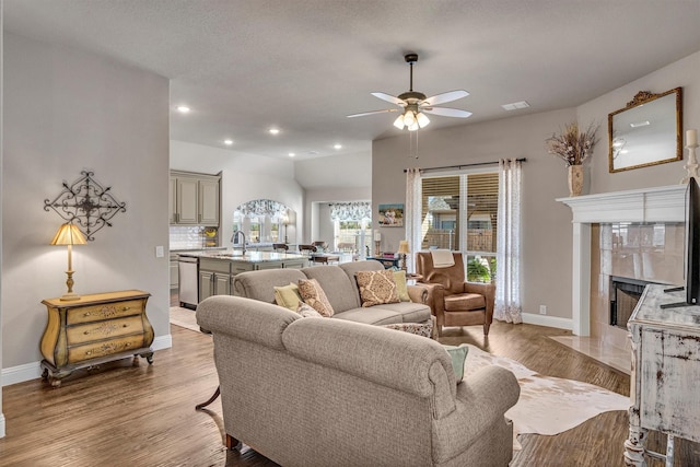 living area with recessed lighting, light wood-style flooring, and baseboards