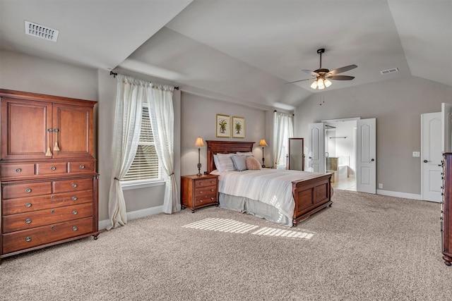 bedroom featuring light colored carpet, vaulted ceiling, and visible vents