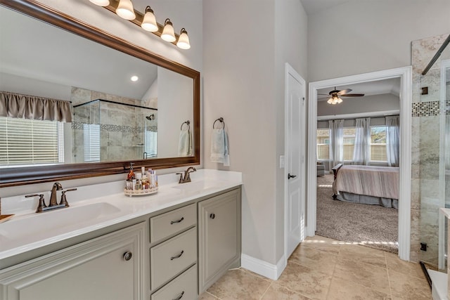 bathroom with lofted ceiling, a shower stall, and a sink