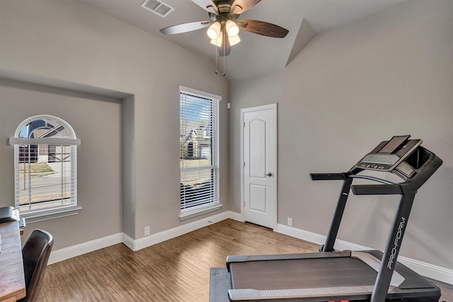 exercise room with visible vents, baseboards, and wood finished floors