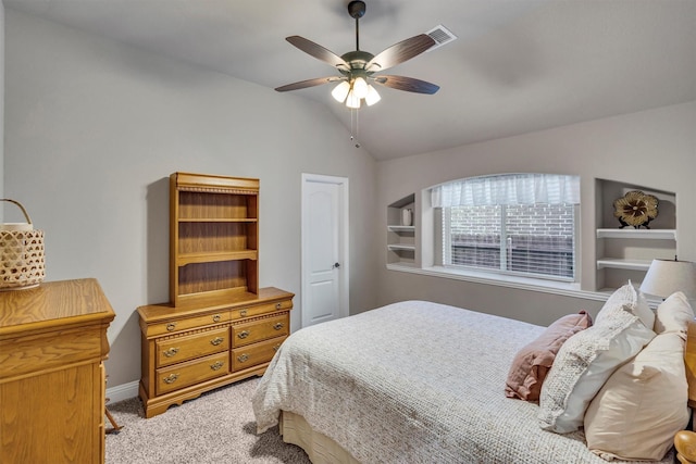 bedroom with a ceiling fan, light carpet, vaulted ceiling, and baseboards