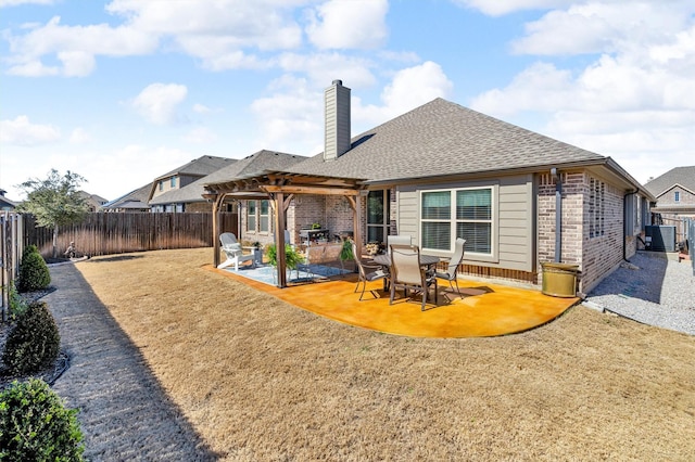 back of property featuring a patio, brick siding, a chimney, and a pergola