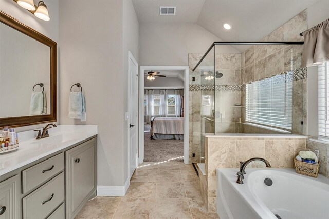 ensuite bathroom with a stall shower, visible vents, vaulted ceiling, and vanity