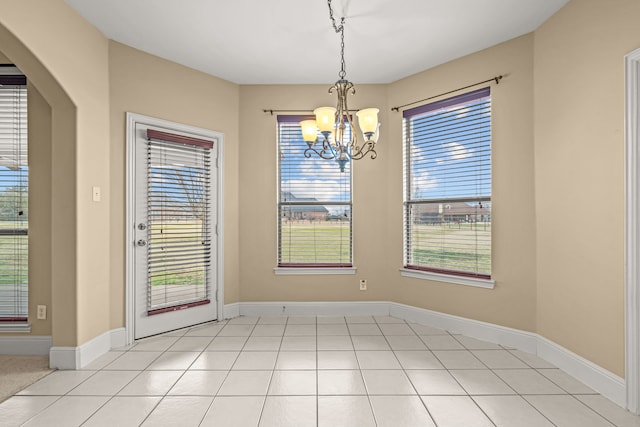 3054 Oakwood Dr, Celina, TX 75009 - unfurnished dining area featuring light tile patterned floors, baseboards, and a chandelier