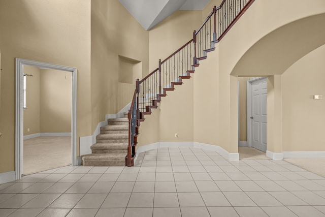 3054 Oakwood Dr, Celina, TX 75009 - entryway featuring baseboards, a high ceiling, arched walkways, and light tile patterned floors