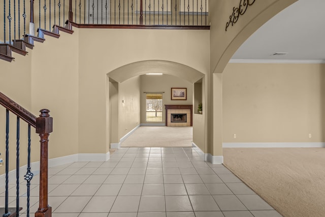 3054 Oakwood Dr, Celina, TX 75009 - tiled entryway featuring carpet floors, arched walkways, stairs, and visible vents