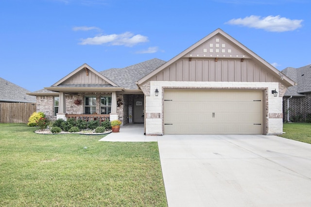 view of front of home with an attached garage, a shingled roof, a front yard, and brick siding