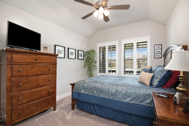 carpeted bedroom featuring a ceiling fan, lofted ceiling, and baseboards