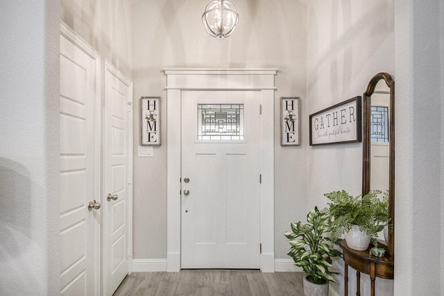 entrance foyer featuring baseboards and wood finished floors