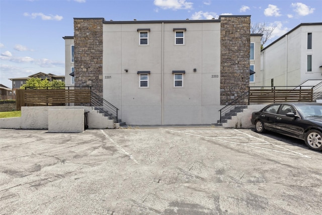 view of side of property with uncovered parking