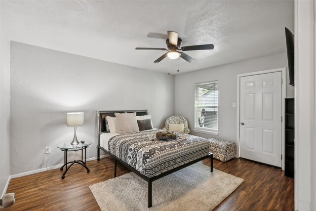 bedroom with a ceiling fan, baseboards, and wood finished floors
