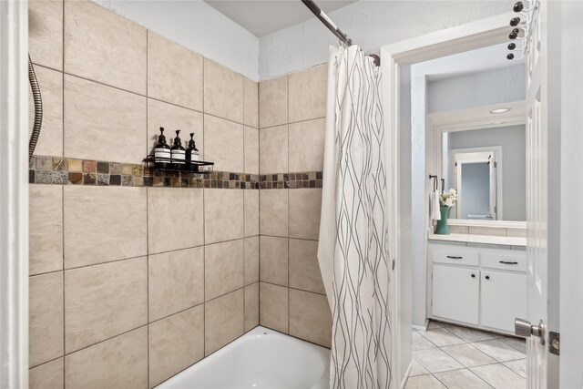 full bathroom with tile patterned flooring, vanity, and shower / bath combo