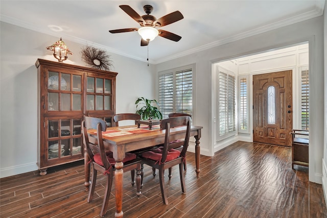 dining area with crown molding, baseboards, ceiling fan, and dark wood-type flooring