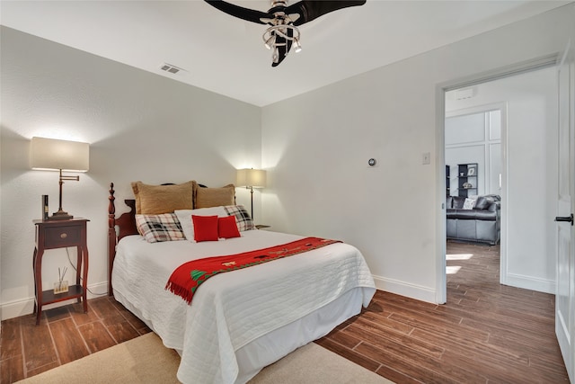 bedroom with wood tiled floor, visible vents, and baseboards