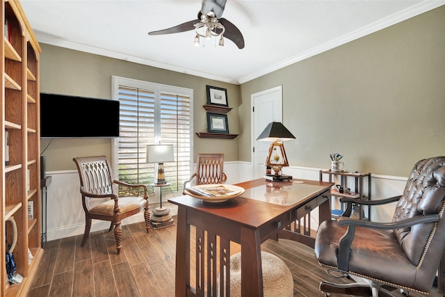 office space featuring dark wood-style floors, ornamental molding, a ceiling fan, and wainscoting