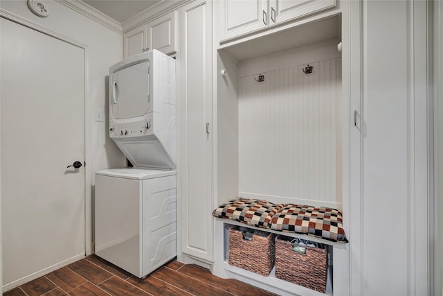 mudroom featuring wood tiled floor, crown molding, and stacked washer and clothes dryer