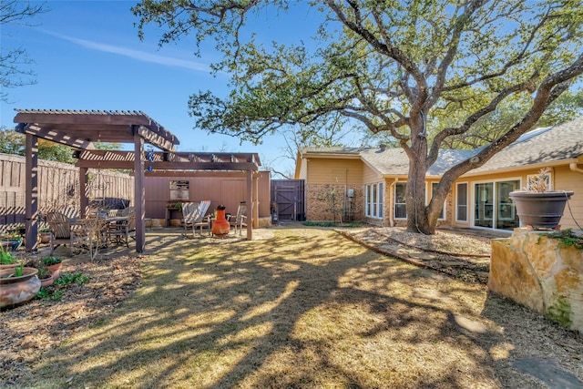 view of yard with a patio, a fenced backyard, a gate, and a pergola