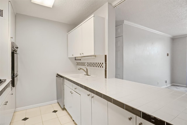 kitchen featuring a sink, stainless steel dishwasher, and white cabinetry