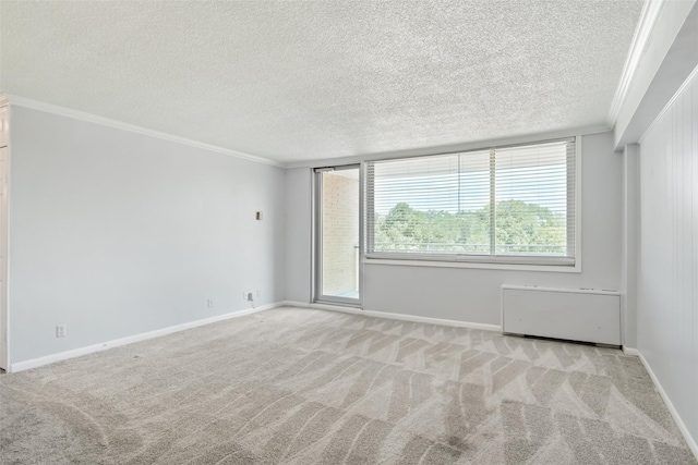 carpeted spare room featuring baseboards, a textured ceiling, and ornamental molding