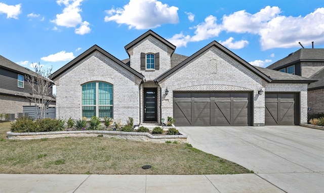 french provincial home featuring a garage, brick siding, driveway, and a front lawn