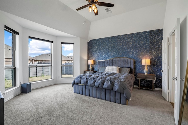 bedroom with carpet floors, an accent wall, visible vents, and wallpapered walls