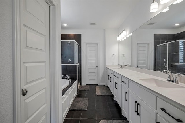 full bath featuring double vanity, a shower stall, a sink, and tile patterned floors