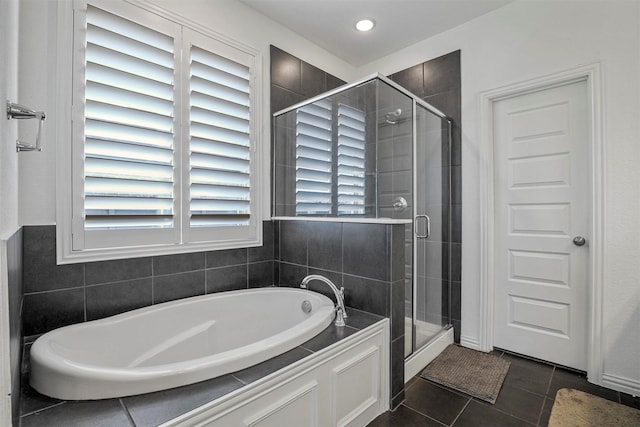 full bath with a shower stall, a bath, and tile patterned floors