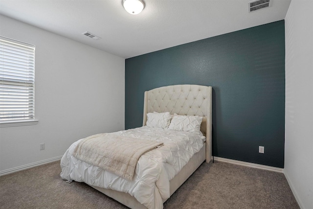 carpeted bedroom with baseboards and visible vents