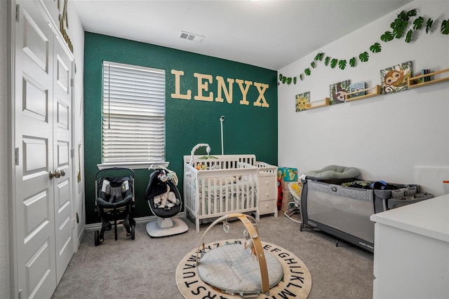 carpeted bedroom featuring visible vents