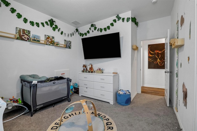 carpeted bedroom with visible vents and baseboards