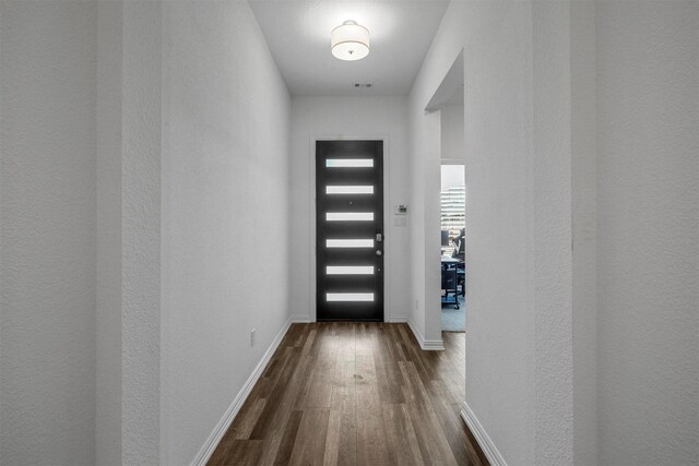 entryway with baseboards and dark wood-type flooring