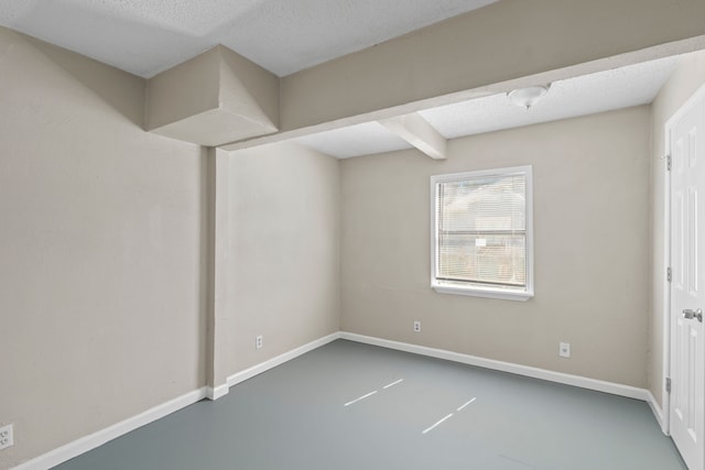 6518 Meade St, Dallas, TX 75232 - unfurnished room featuring a textured ceiling, finished concrete flooring, and baseboards