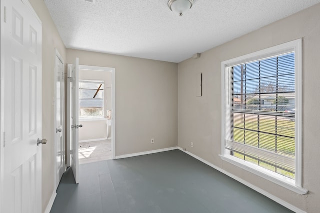 6518 Meade St, Dallas, TX 75232 - interior space featuring multiple windows, a textured ceiling, and baseboards