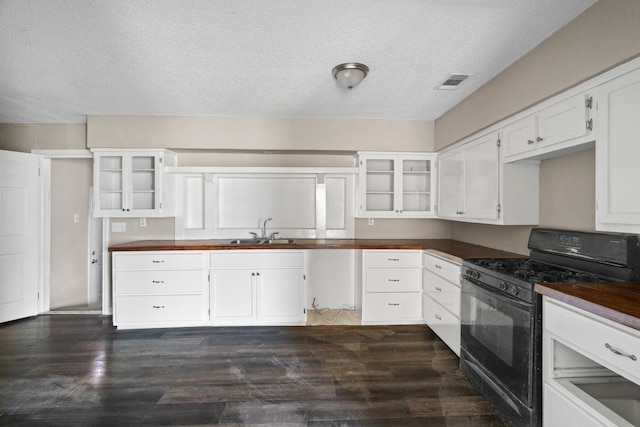 6518 Meade St, Dallas, TX 75232 - kitchen with visible vents, black range with gas stovetop, dark wood-type flooring, white cabinetry, and a sink