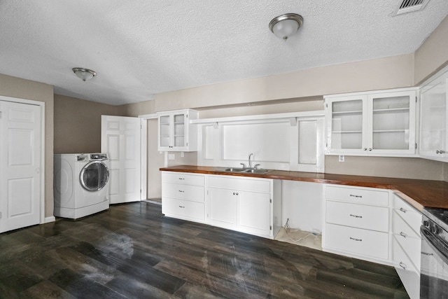 6518 Meade St, Dallas, TX 75232 - kitchen with white cabinets, range with gas stovetop, washer / clothes dryer, dark wood-type flooring, and a sink