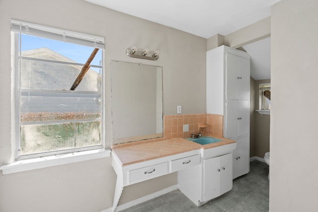 6518 Meade St, Dallas, TX 75232 - bathroom with vanity, toilet, and decorative backsplash