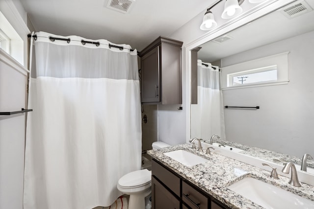 bathroom with visible vents, toilet, and a sink