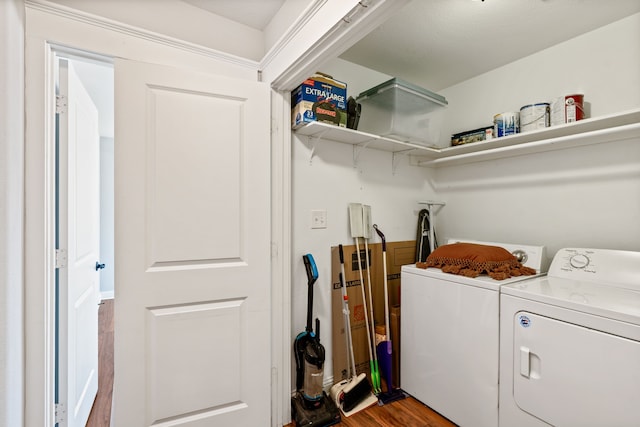 washroom featuring laundry area, wood finished floors, and independent washer and dryer