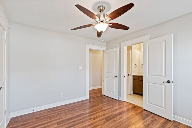 unfurnished bedroom with ceiling fan, light wood-type flooring, and baseboards