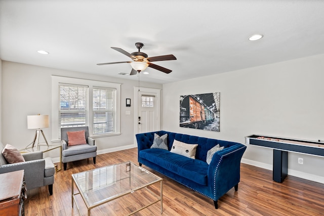 living area featuring baseboards and wood finished floors