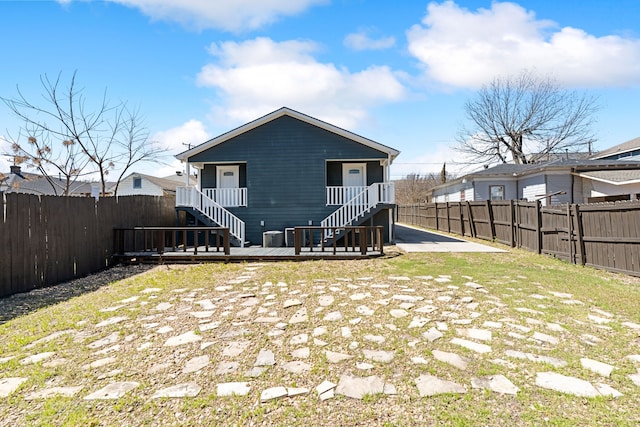 back of house with a wooden deck, stairs, and a fenced backyard