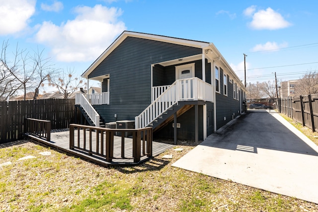 rear view of house featuring stairs and fence