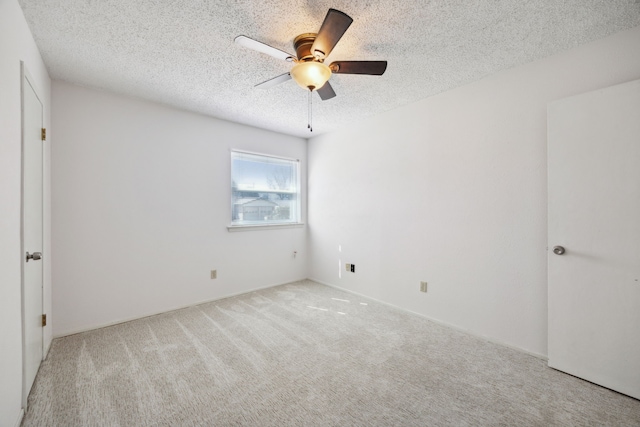 unfurnished bedroom featuring carpet flooring, ceiling fan, and a textured ceiling