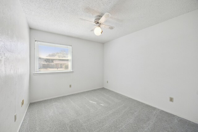 unfurnished room with a textured ceiling, a ceiling fan, and carpet flooring