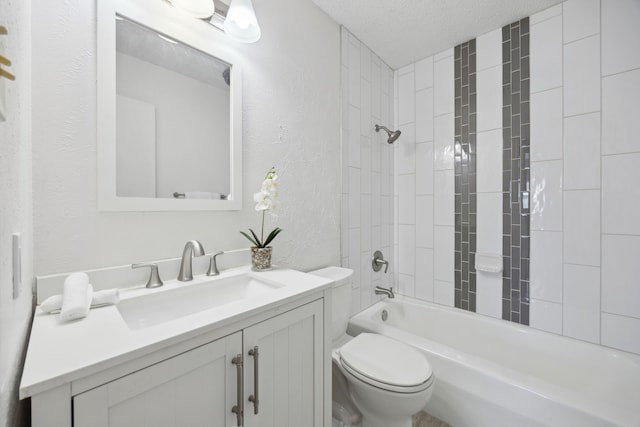 bathroom featuring a textured wall, toilet, washtub / shower combination, a textured ceiling, and vanity